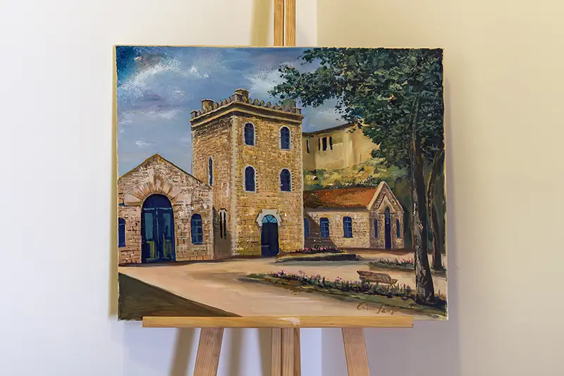 Pintura do edifício antigo das Termas das Caldas da Felgueira num cavalete de exposição