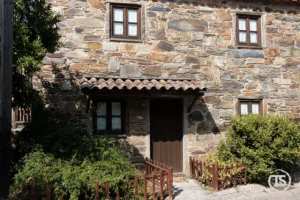 Casa tradicional de xisto na Aldeia da Figueira com portas e janelas de madeira
