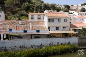 Aljezur o que visitar — vista da vila branca entre o vale e o rio na Costa Vicentina