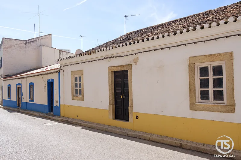 Casas tradicionais de Alcantarilha com faixas coloridas e portas simples
